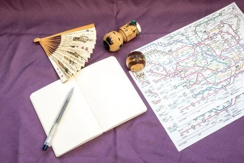 Planning trip to japan using metro map and traditional souvenirs Stock Photos