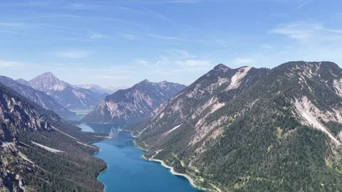 Plansee lake aerial drone pull back, mountain valley reveal, Reutte Austria Stock Footage 346414103