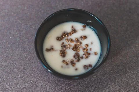 Plant-based breakfast ideas, dark chocolate coated granola with oat milk Stock Photos
