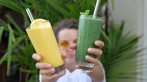 Plant based cold refreshing natural drinks options. Blonde girl dancing with Stock Footage 153388265