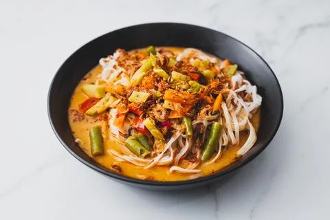 Plant-based dan dan rice noodles soup with mixed vegetables and spicy sauce Stock Photos