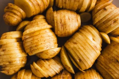 Plant-based hasselback potatoes about to go in the oven Stock Photos
