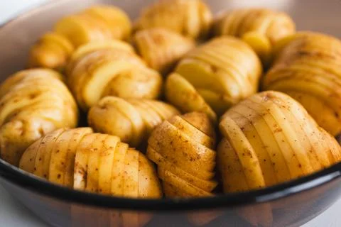 Plant-based hasselback potatoes about to go in the oven Stock Photos