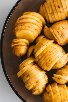Plant-based hasselback potatoes about to go in the oven Stock Photos