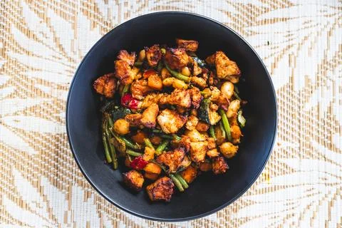 Plant-based sauteed vegetables with marinated tofu chunks Stock Photos