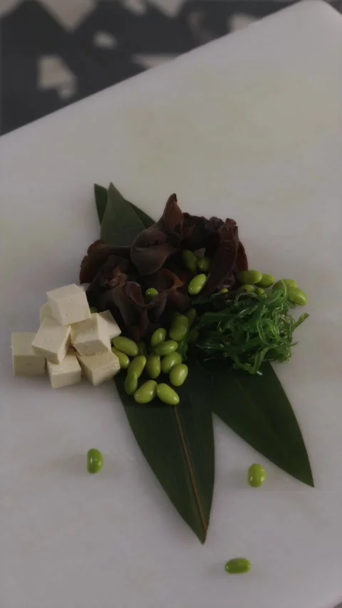 Plant based sushi roll ingredients displayed on white cutting board Stock-Footage 337119177