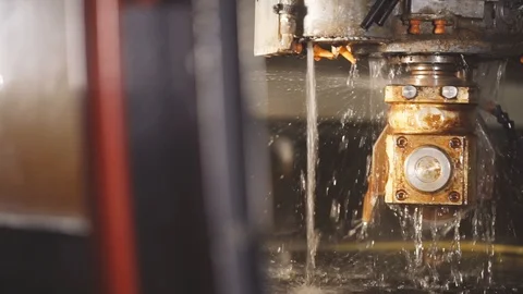The plant operates a machine and cuts a mirror cooled with water Stock Footage 105367999