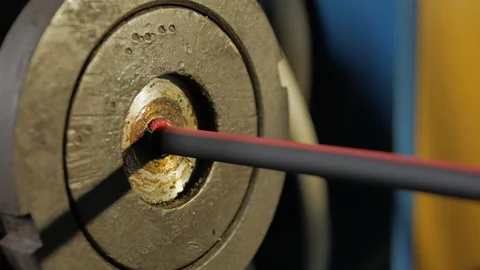 Plant for the production of the cable. Covering the copper cable with a sheath. Stock Footage 125251817