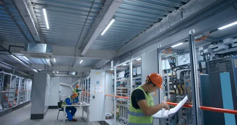 The plant specialists in the control room where the main control equipment  Stock Footage 161976522
