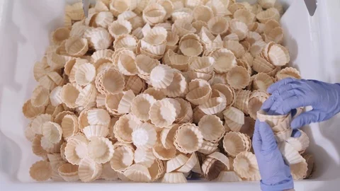 Plant worker puts waffle baskets together to package in box Stock Footage 124170206