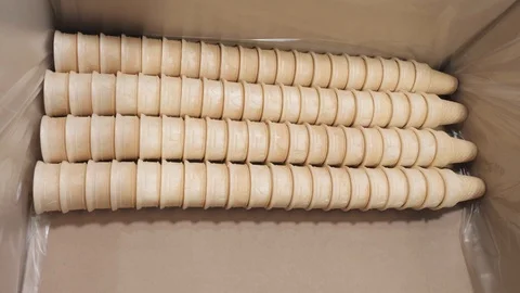 Plant worker puts waffle cups in box preparing for delivery Stock Footage 124299411