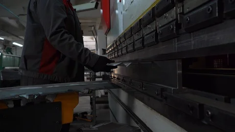 Plant, workshop for production of metal structures, worker uses large press Stock Footage 120064188