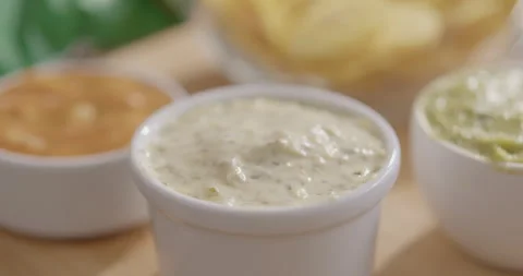 Plantain Chips Dipping into Sauce - Appetizing Snack Video Stock Footage 264791751