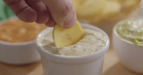 Plantain Chips Dipping into Sauce - Appetizing Snack Video Stock Footage 264791758