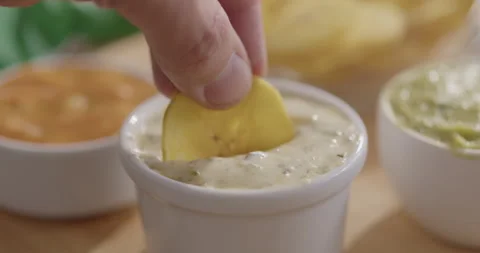 Plantain Chips Dipping into Sauce - Appetizing Snack Video Stock Footage 264791813