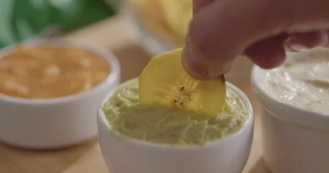 Plantain Chips Dipping into Sauce - Appetizing Snack Video Stock Footage 264791819