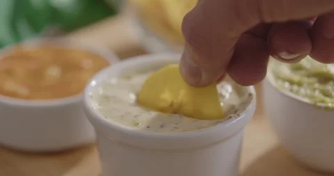 Plantain Chips Dipping into Sauce - Appetizing Snack Video Stock Footage 264791835