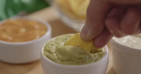 Plantain Chips Dipping into Sauce - Appetizing Snack Video Stock Footage 264791871