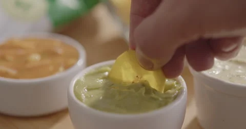 Plantain Chips Dipping into Sauce - Appetizing Snack Video Stock Footage 264791899