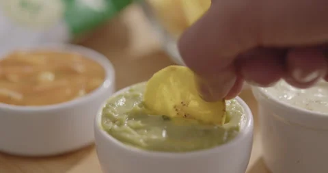 Plantain Chips Dipping into Sauce - Appetizing Snack Video Stock Footage 264791930