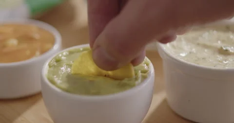 Plantain Chips Dipping into Sauce - Appetizing Snack Video Stock Footage 264791949