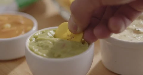 Plantain Chips Dipping into Sauce - Appetizing Snack Video Stock Footage 264791983