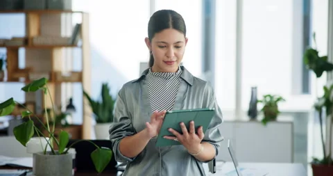 Plants, reading and tablet with business woman in green office for net zero Stock Footage 321124907