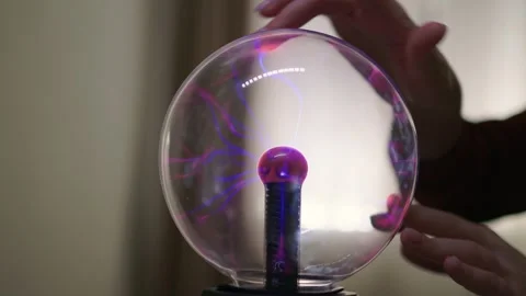 Plasma ball. Hands holding plasma light ball. Plasma ball light ray science Stock Footage 261885888