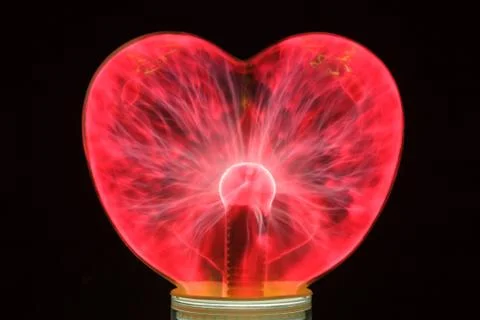 Plasma ball heart glowing in the dark Stock Photos