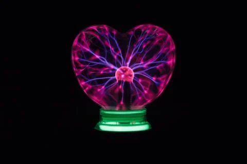 Plasma ball heart glowing in the dark Stock Photos