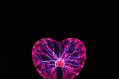 Plasma ball heart glowing in the dark Stock Photos