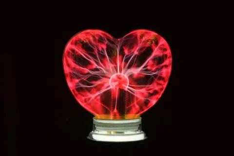 Plasma ball heart glowing in the dark Stock Photos
