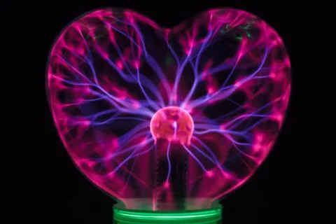 Plasma ball heart glowing in the dark Foto stock