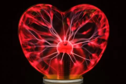 Plasma ball heart glowing in the dark Stock Photos