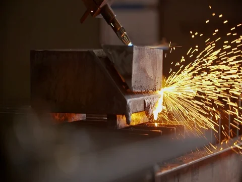 Plasma cutter cutting through a block of metal Stock Footage 75406269