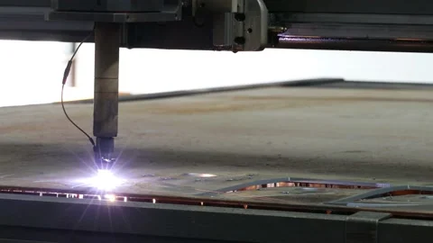 The plasma cutter at a machine building enterprise cuts a metal billet spark Stock Footage 154275457