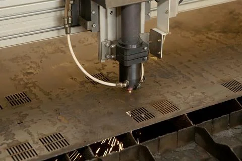 Plasma cutting CNC machine cuts metal material with sparks, industry backgrou Stock Photos