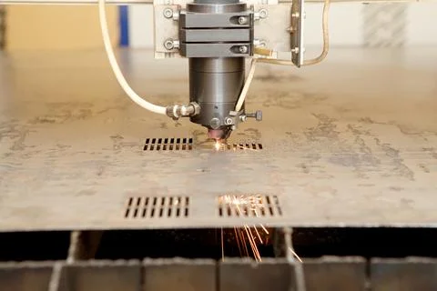 Plasma cutting CNC machine cuts metal material with sparks, industry backgrou Stock Photos