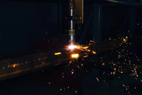 A plasma cutting machine cuts perforations on a pipe. Production of a well fi Stock Photos
