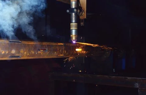 A plasma cutting machine cuts perforations on a pipe. Production of a well fi Stock Photos