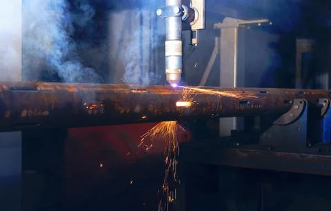 A plasma cutting machine cuts perforations on a pipe. Production of a well fi Stock Photos