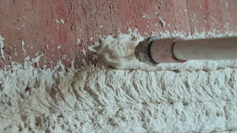 Plaster Applied to Brick Wall Using Special Sprayer Stock Footage 317380681