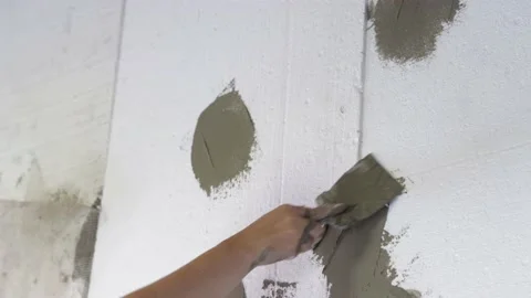 Plaster is applied to the foam, insulation of the facade of the house Vídeos de archivo 219200296