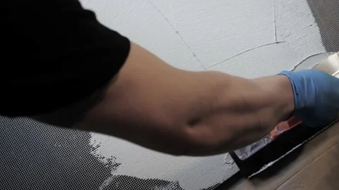 Plaster is applied to a special mesh. stains and coating texture Stock Footage 157428747