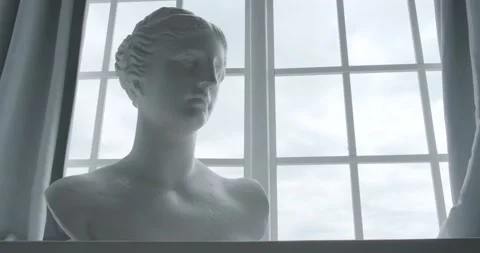Plaster bust in antique style on the background of the window Video stock 194114510