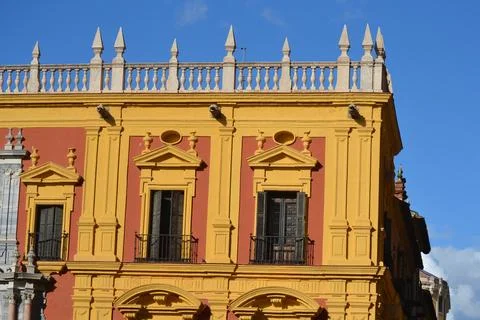 Plaster covers the facade of the building in the image. Arches repeat in rows Stock Photos