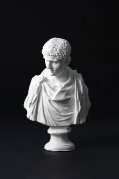Plaster figure in black background	 Stock Photos