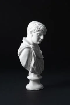 Plaster figure in black background	 Stock Photos