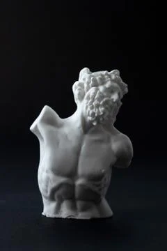 Plaster figure in black background	 Stock Photos