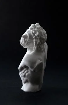 Plaster figure in black background	 Stock Photos
